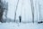a man standing in the middle of a snowy forest