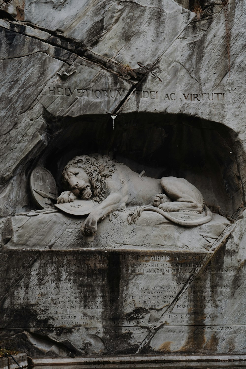 a statue of a lion laying in a cave