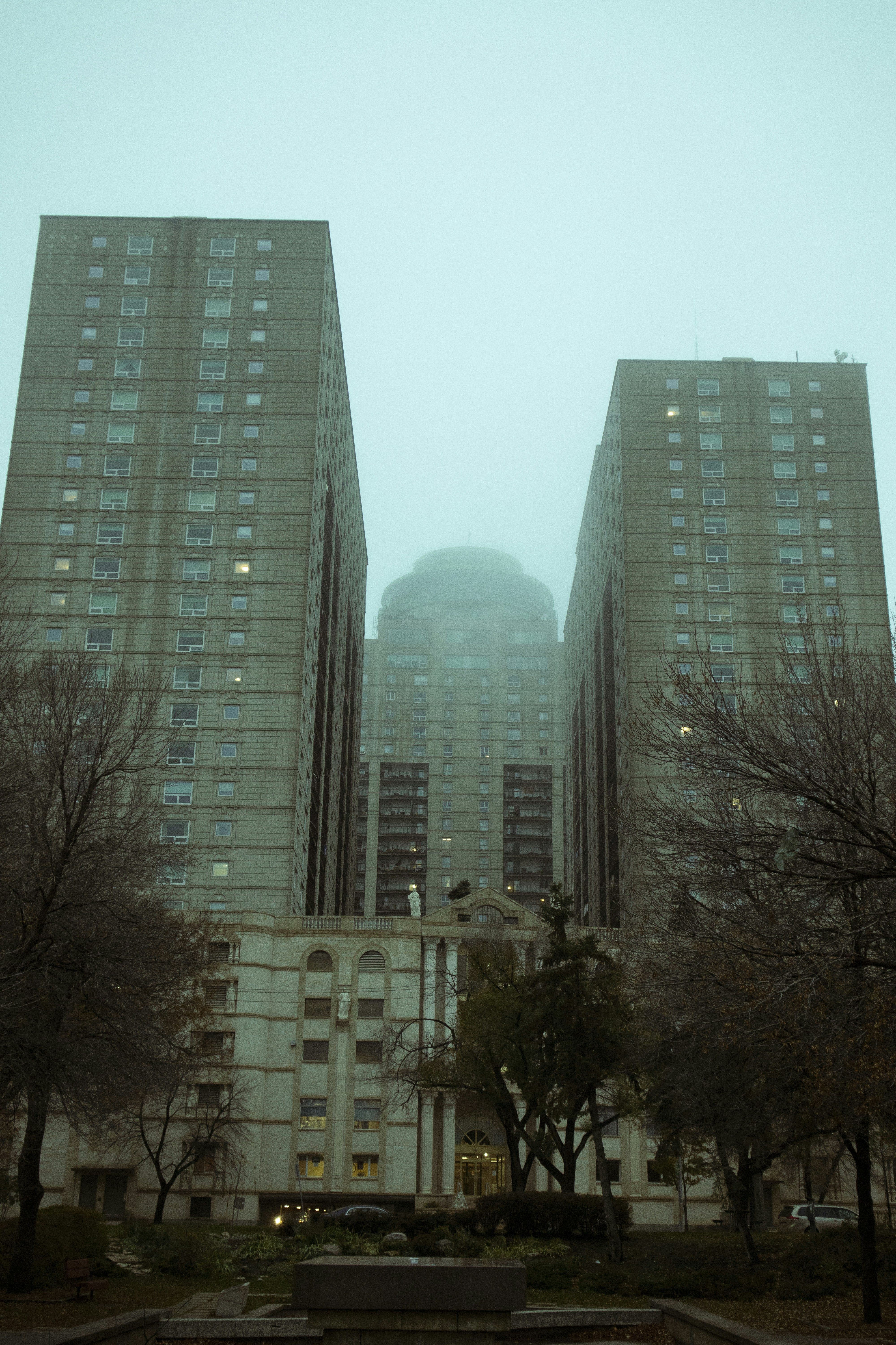 a couple of tall buildings sitting next to each other