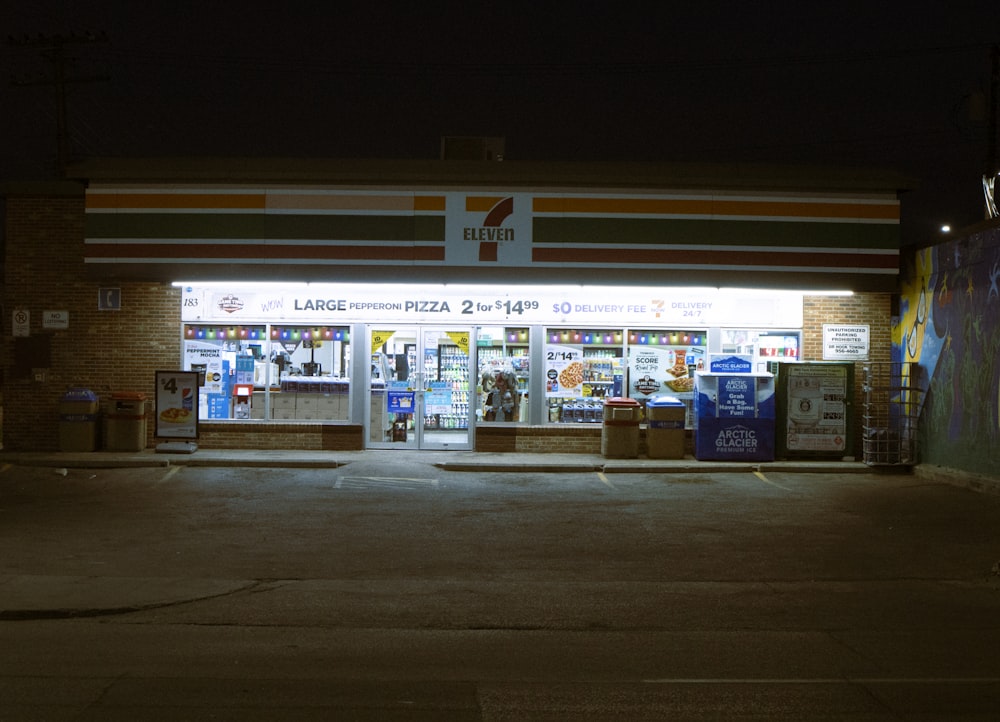 a store front at night with the lights on