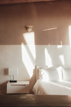 A serene bedroom with soft lighting and minimal decor.