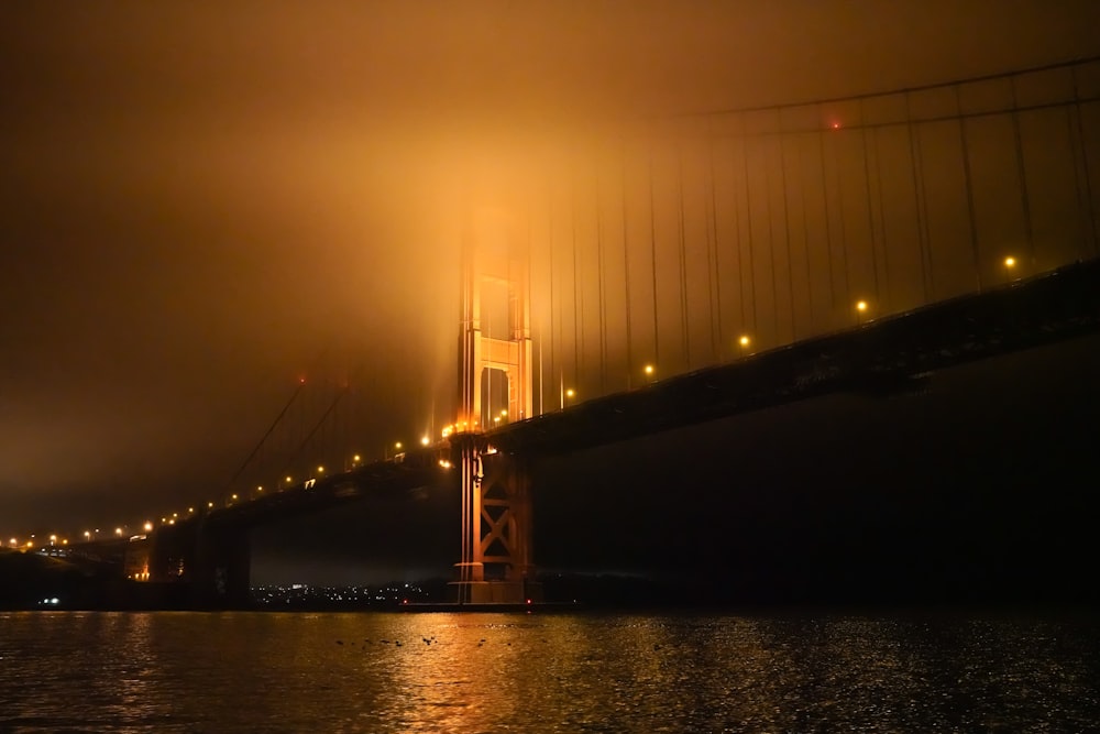 the golden gate bridge is lit up at night