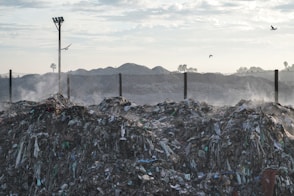 a pile of garbage sitting next to a street light