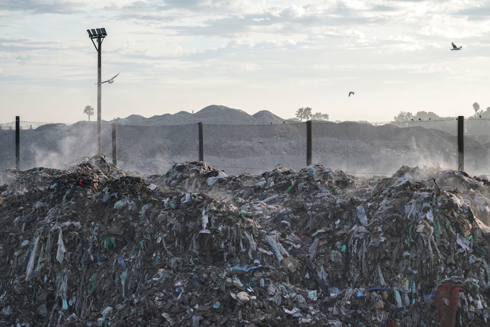 a pile of garbage sitting next to a street light