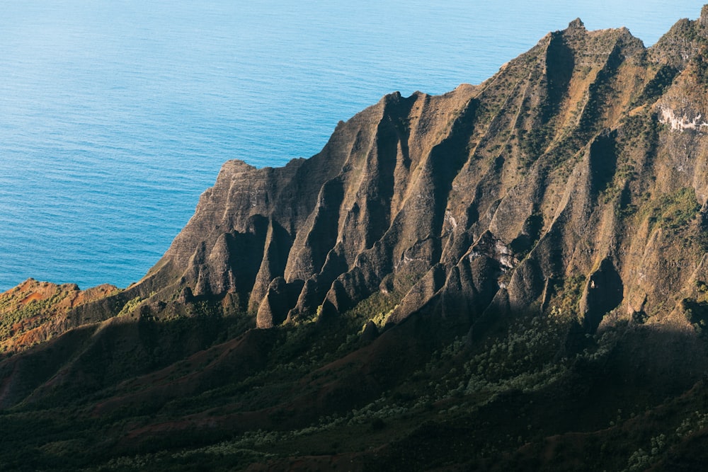 a view of a mountain with a body of water in the background