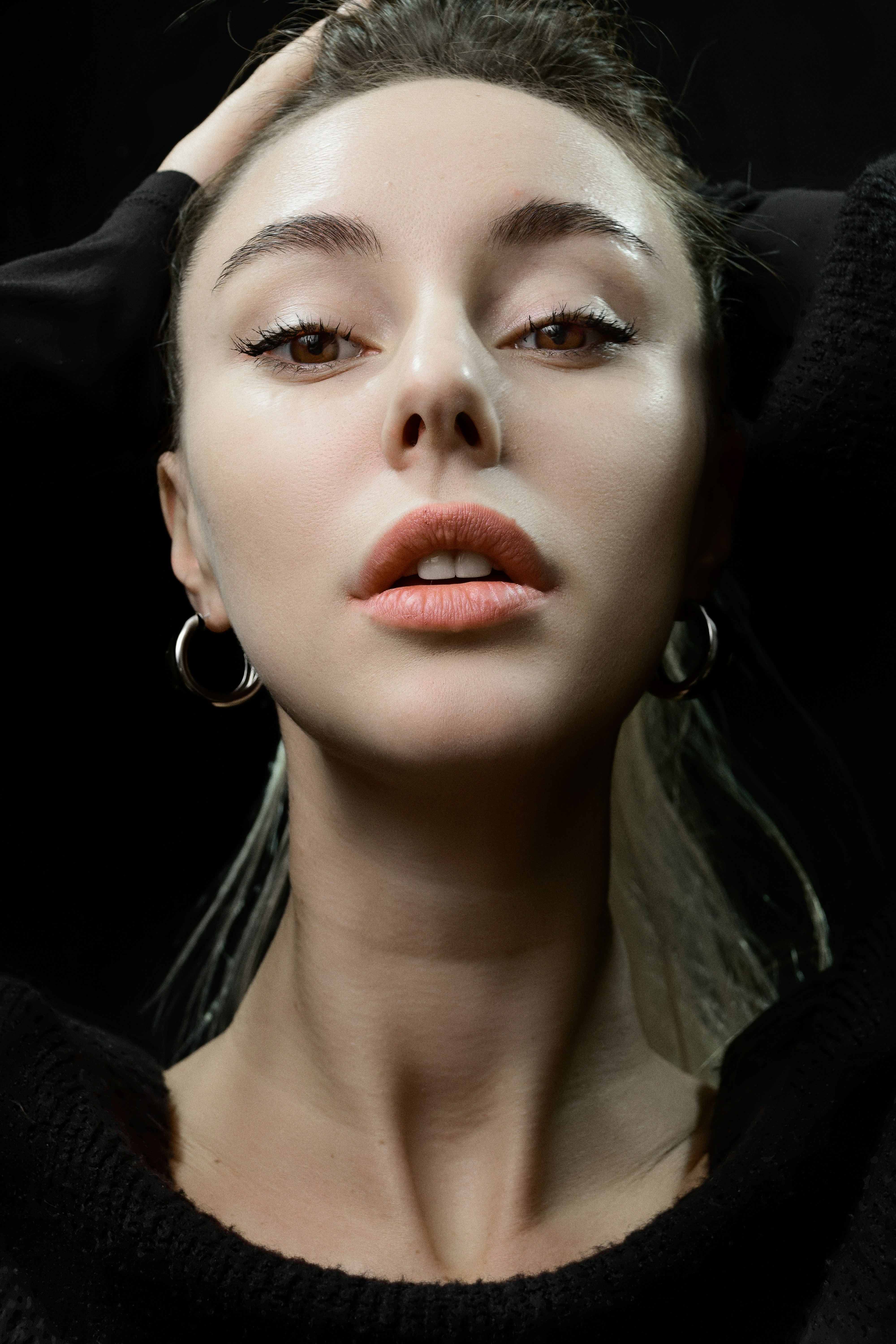 a woman with large hoop earrings on her head