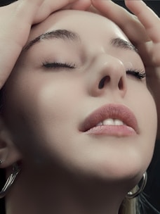 a close up of a woman with her eyes closed
