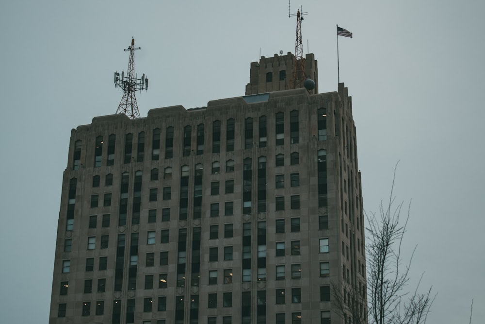 a tall building with a flag on top of it