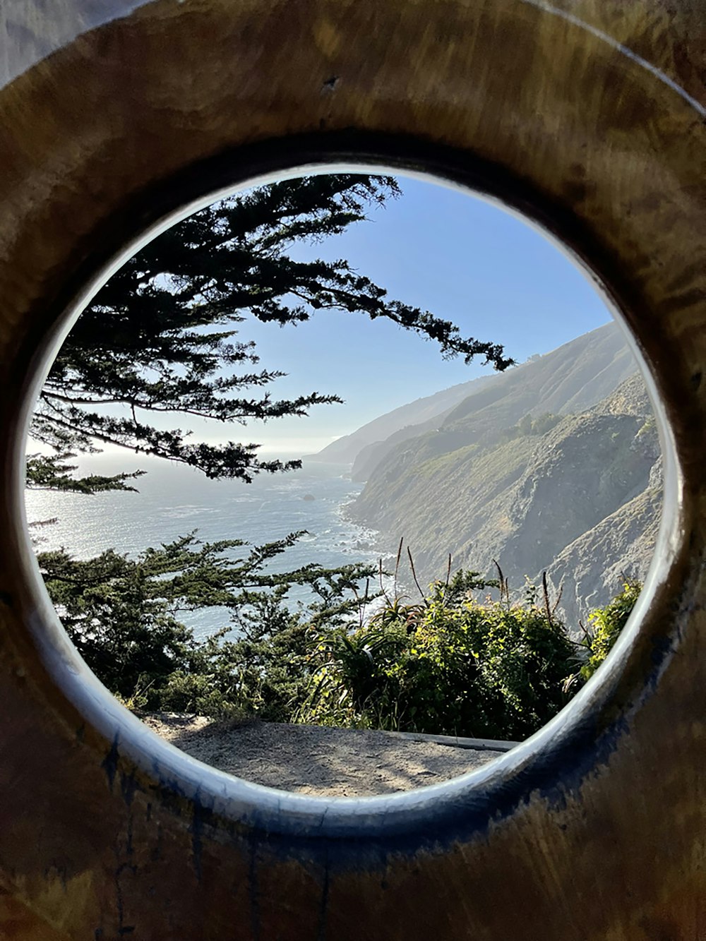 a view of a body of water through a round window