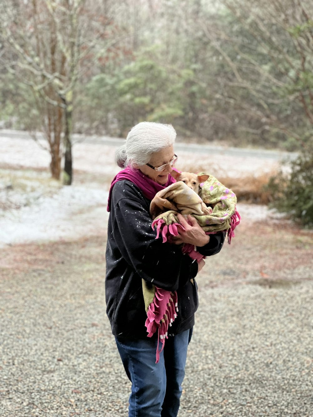 an older woman holding a baby in her arms