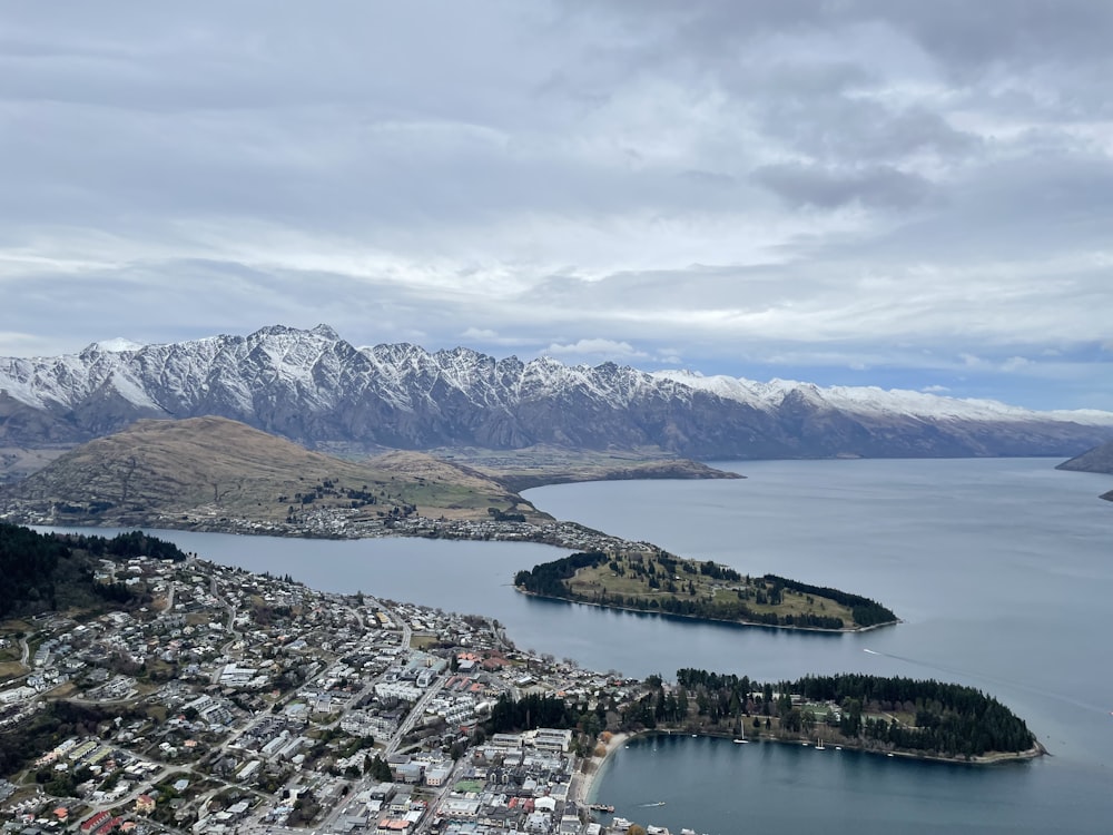 an aerial view of a city with mountains in the background