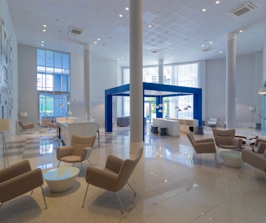 a large lobby with chairs and tables in it
