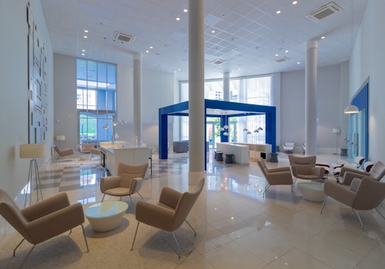 a large lobby with chairs and tables in it