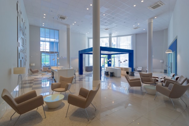 a large lobby with chairs and tables in it