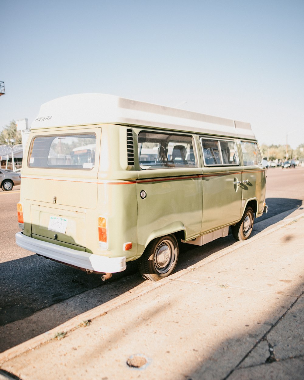 an old van is parked on the side of the road