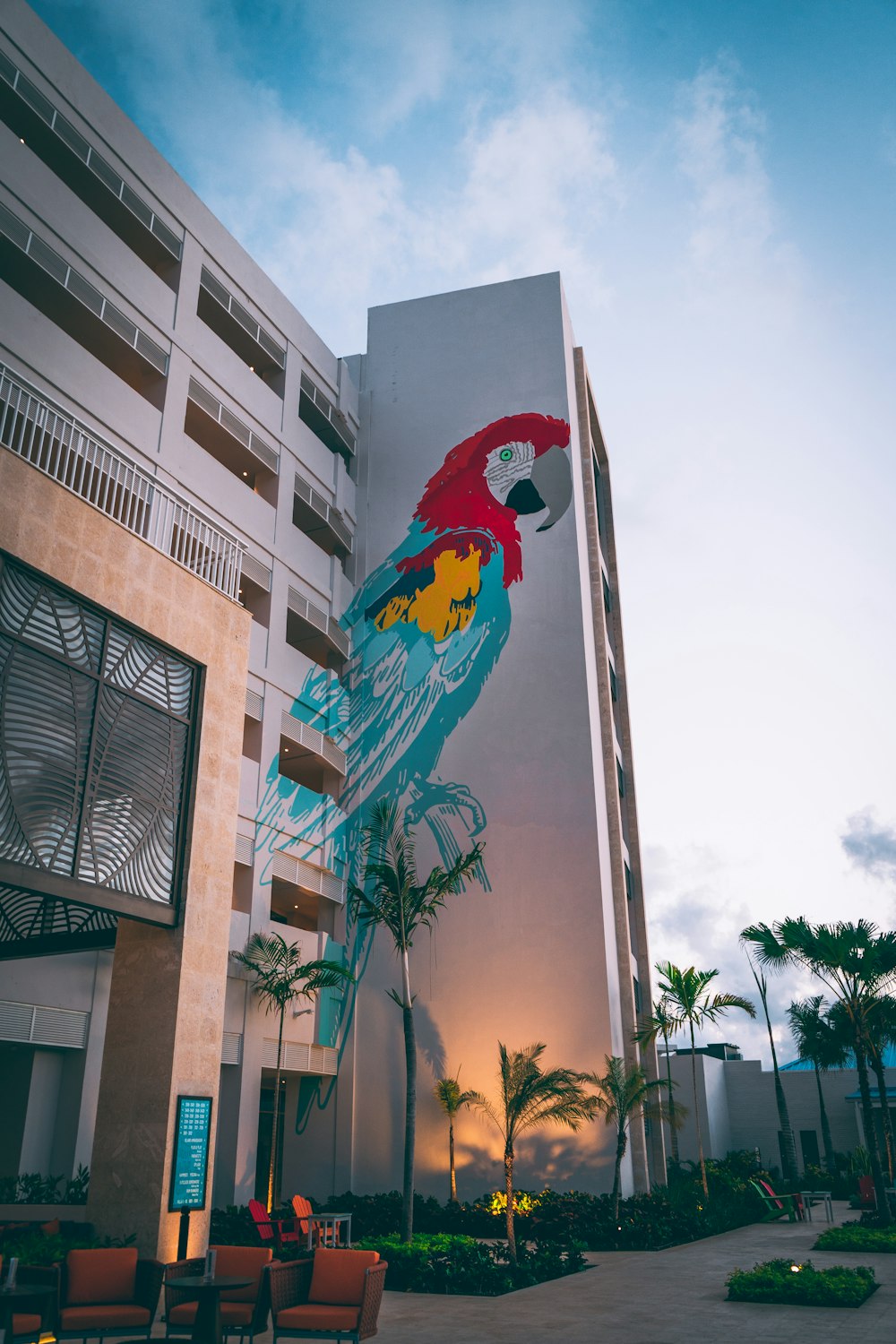 a tall building with a parrot painted on it's side
