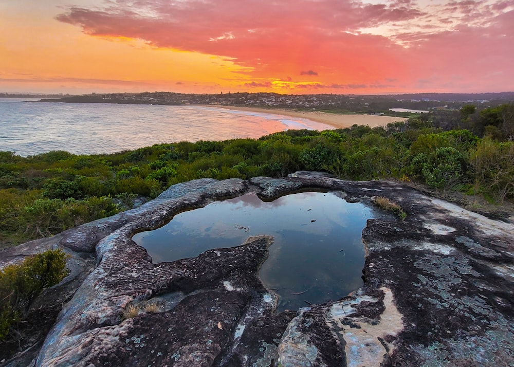 a large rock with a puddle of water in it