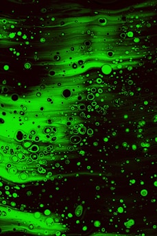 a black and green background with lots of bubbles