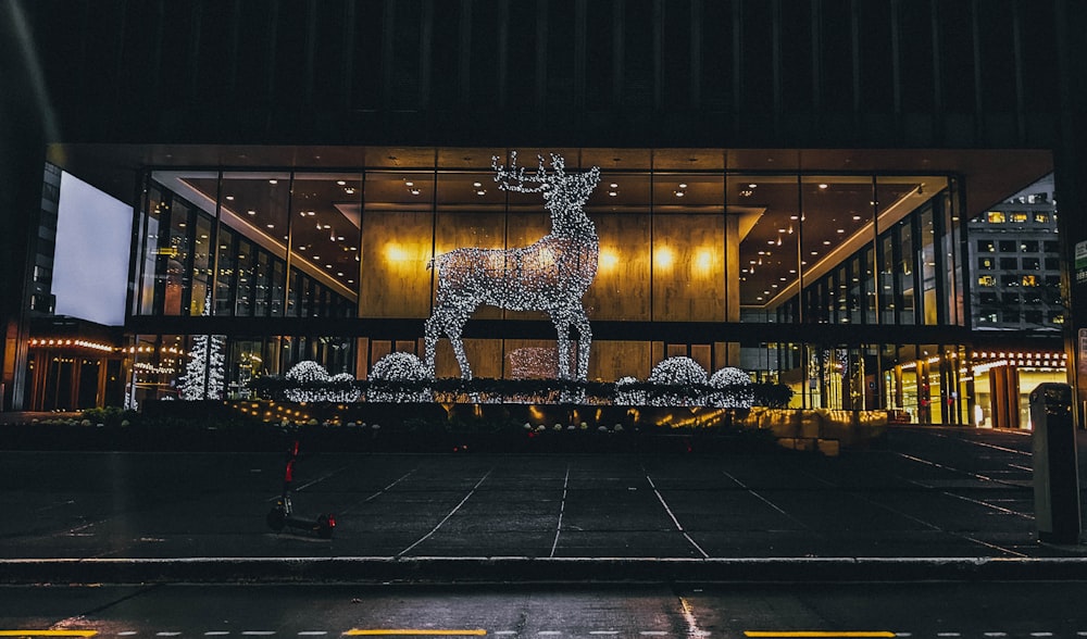 a building with a lit up reindeer on the front of it