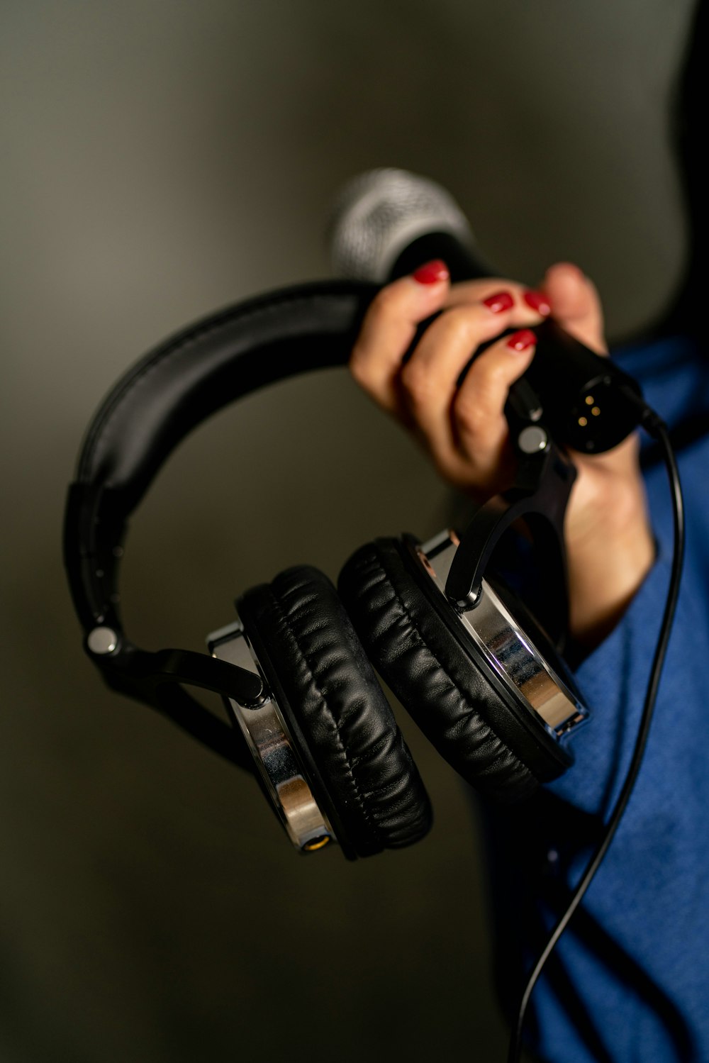 a woman holding a pair of headphones in her hands
