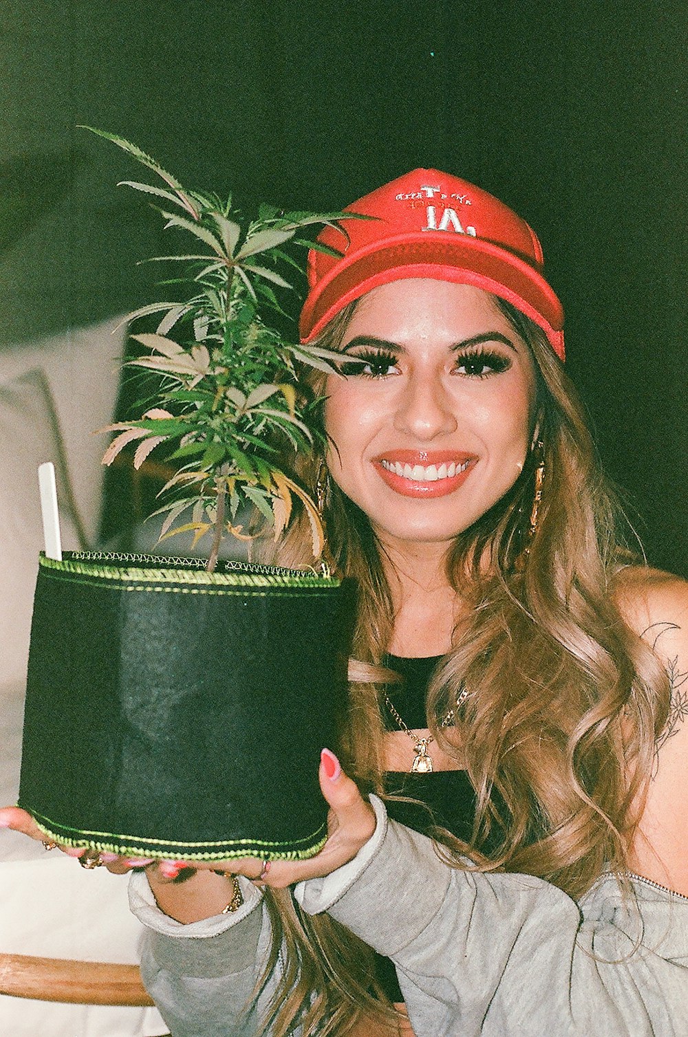 a woman holding a potted plant in her hand