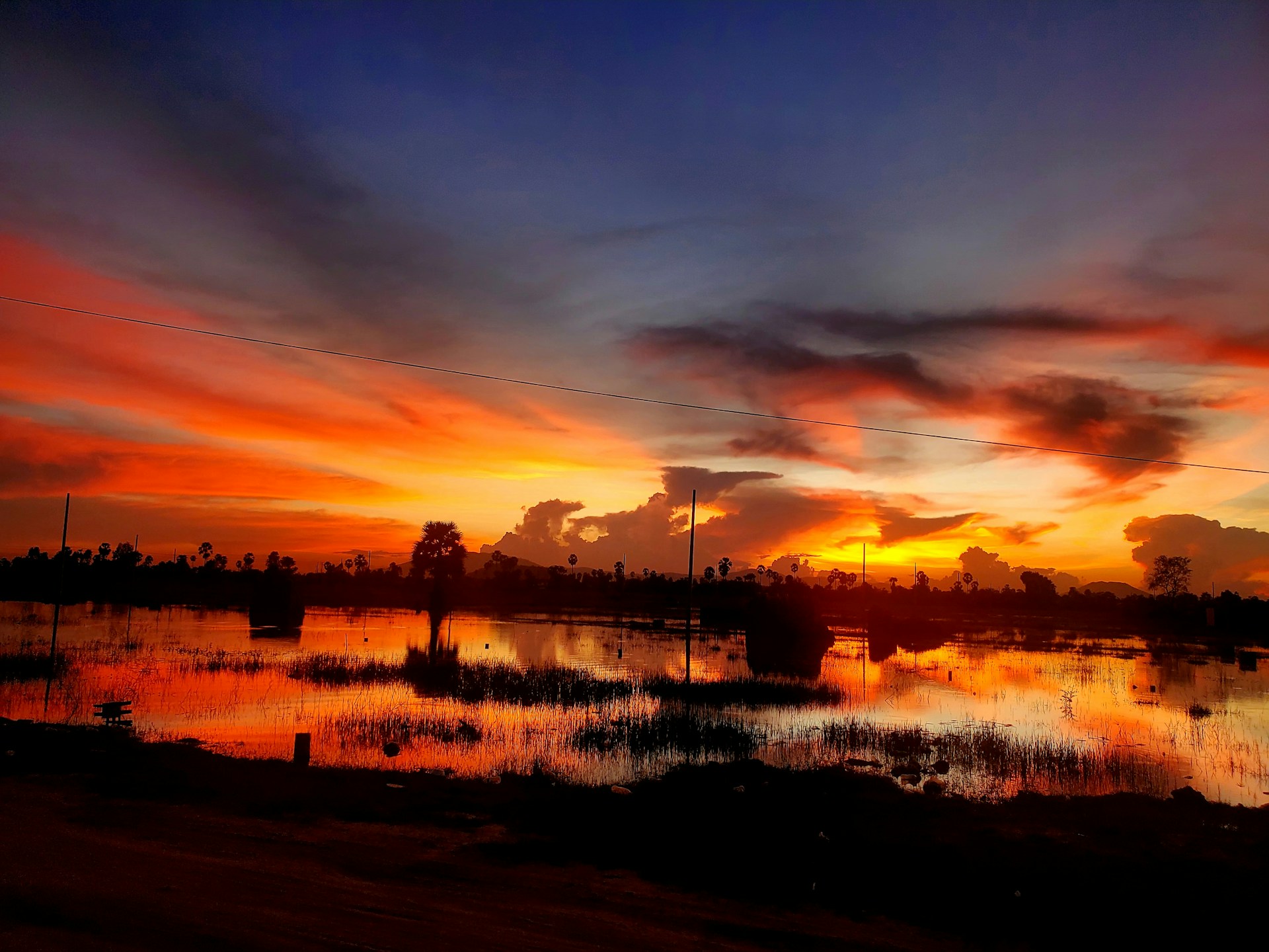 woman wearing yellow long-sleeved dress under white clouds and blue sky during daytime