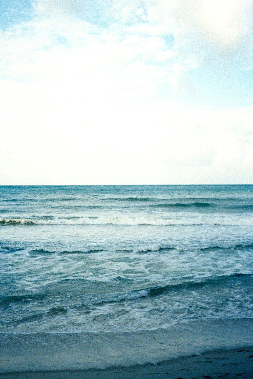 a person riding a surfboard on top of a wave