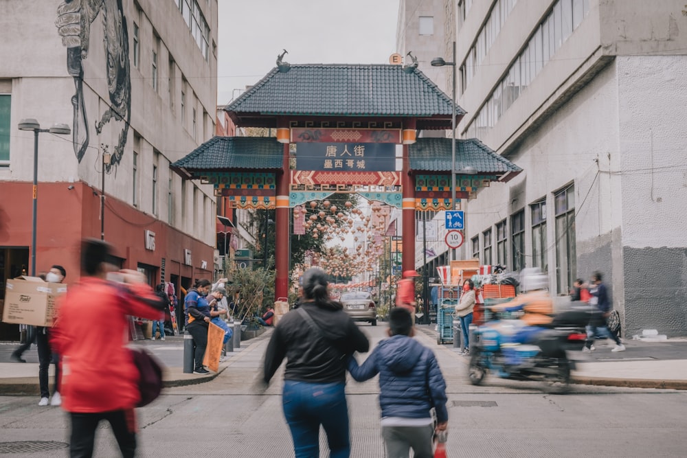 a couple of people that are walking down a street