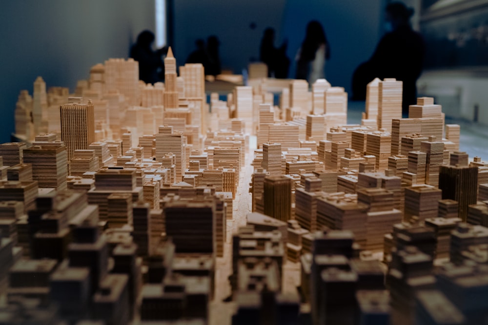a model of a city with people standing around it