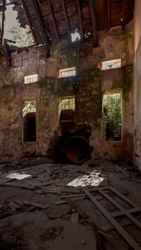 a run down building with broken windows and debris on the ground