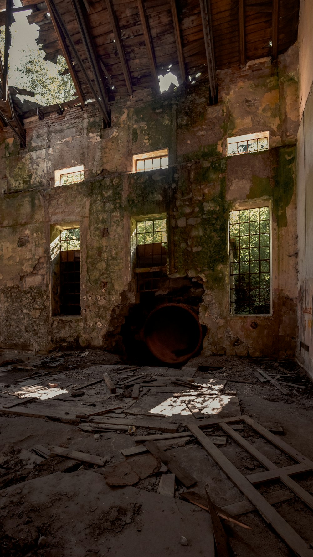 a run down building with broken windows and debris on the ground