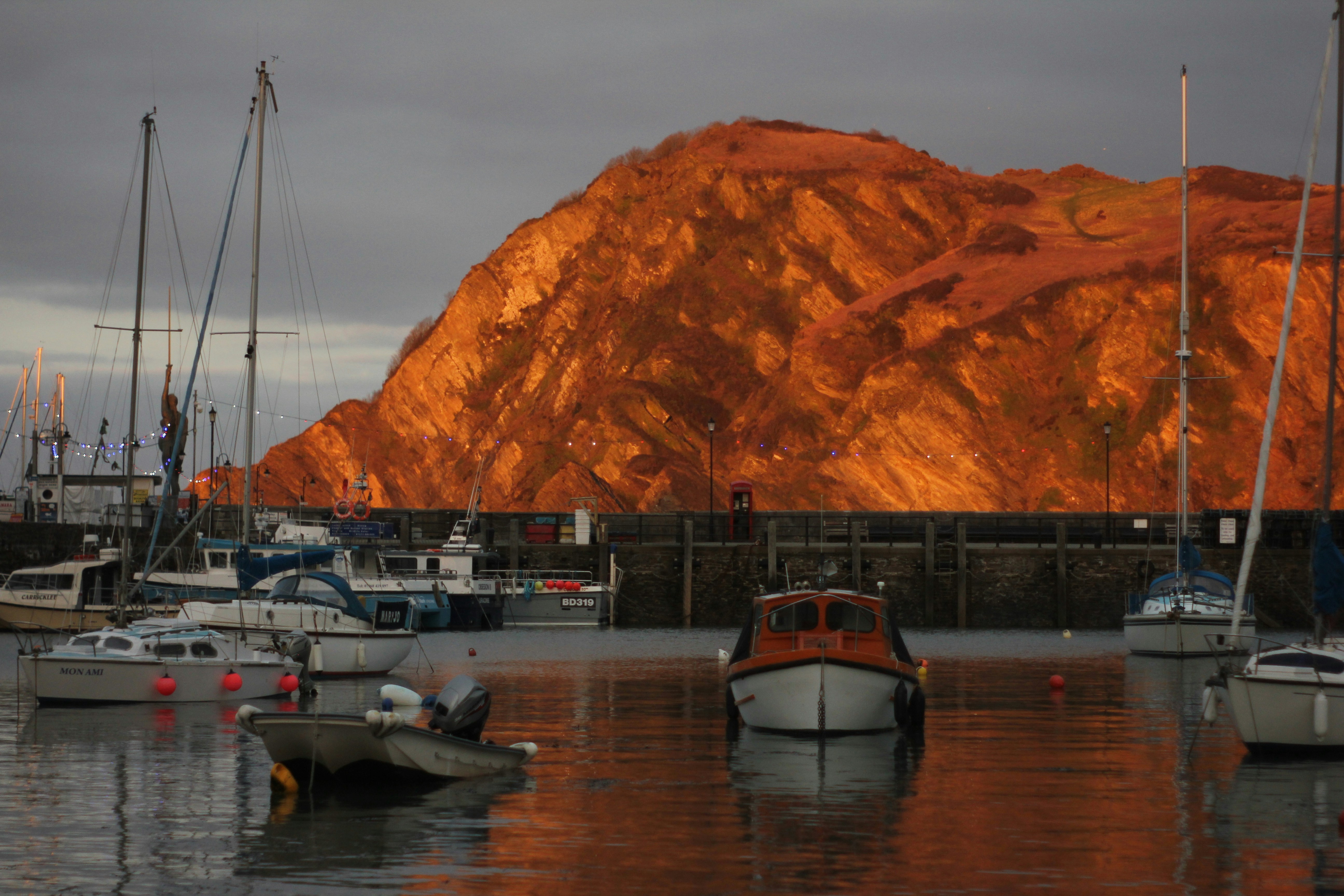 a group of boats floating on top of a body of water