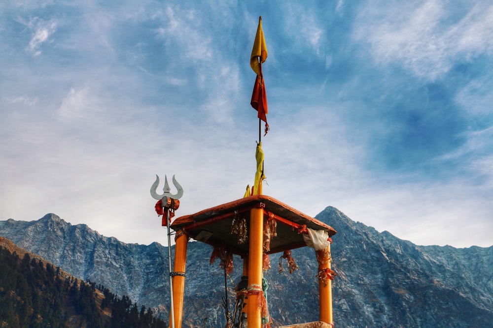 a gazebo with two flags on top of it