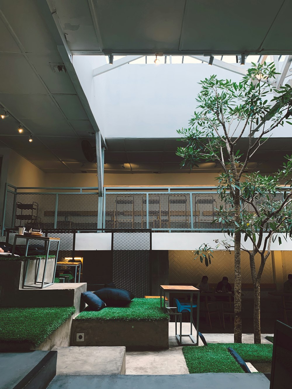 a room with grass and a tree inside of it