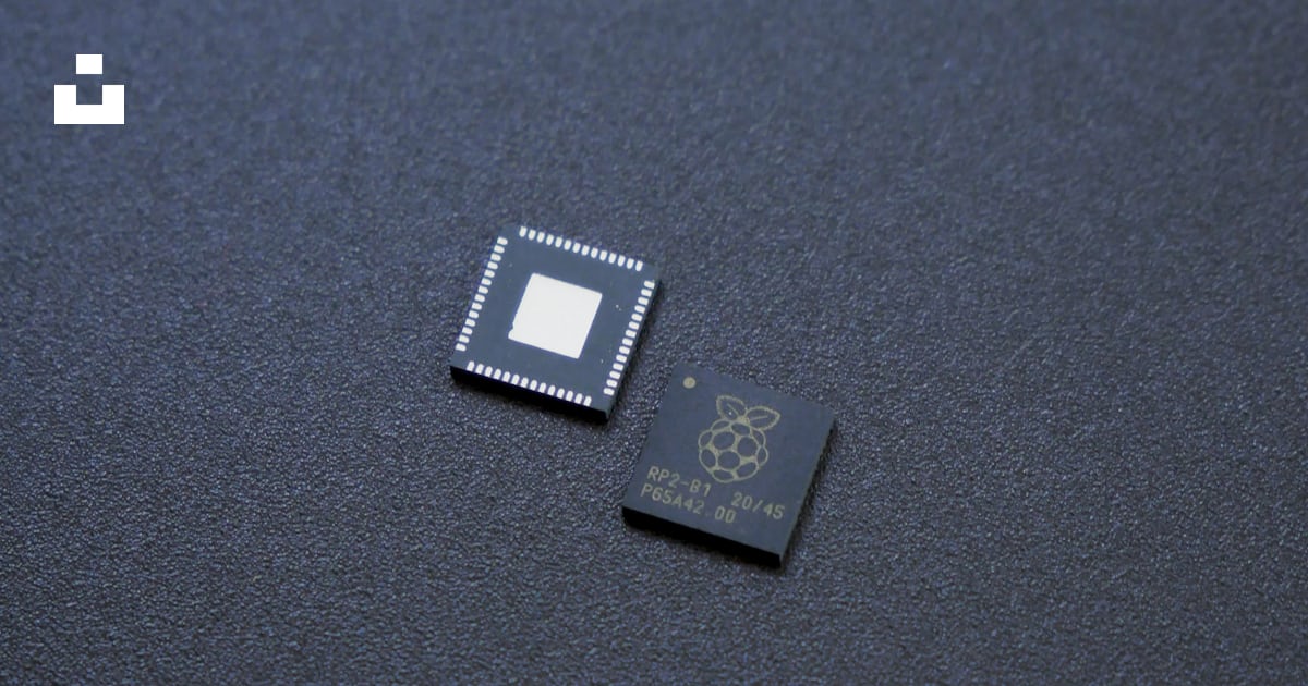 A micro processor chip sitting on top of a table photo – Free ...