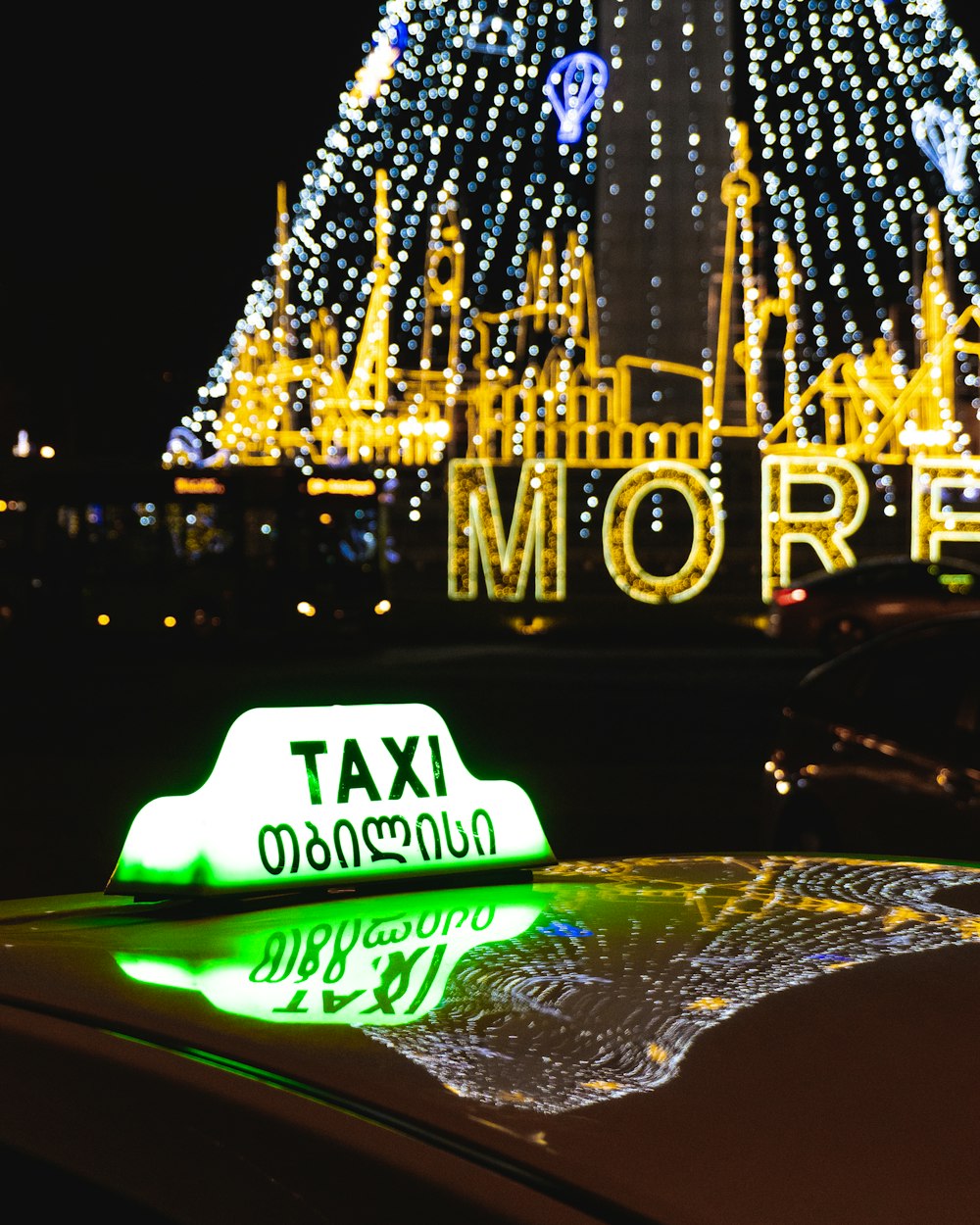 a taxi cab with a christmas tree in the background