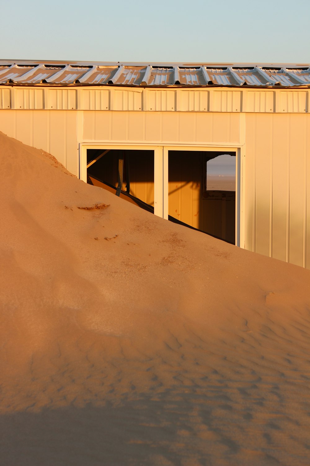 a garage with a roof covered in sand