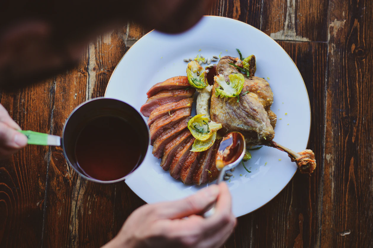 Restaurant plate served beside a cup of coffee on a rustic dining table.
