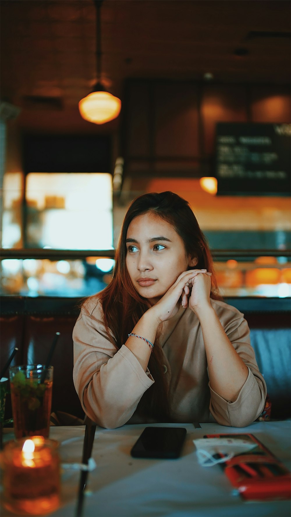 a woman sitting at a table in a restaurant