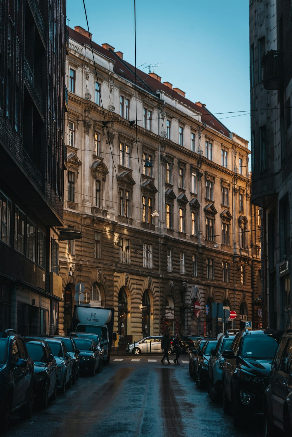 a city street filled with lots of traffic next to tall buildings