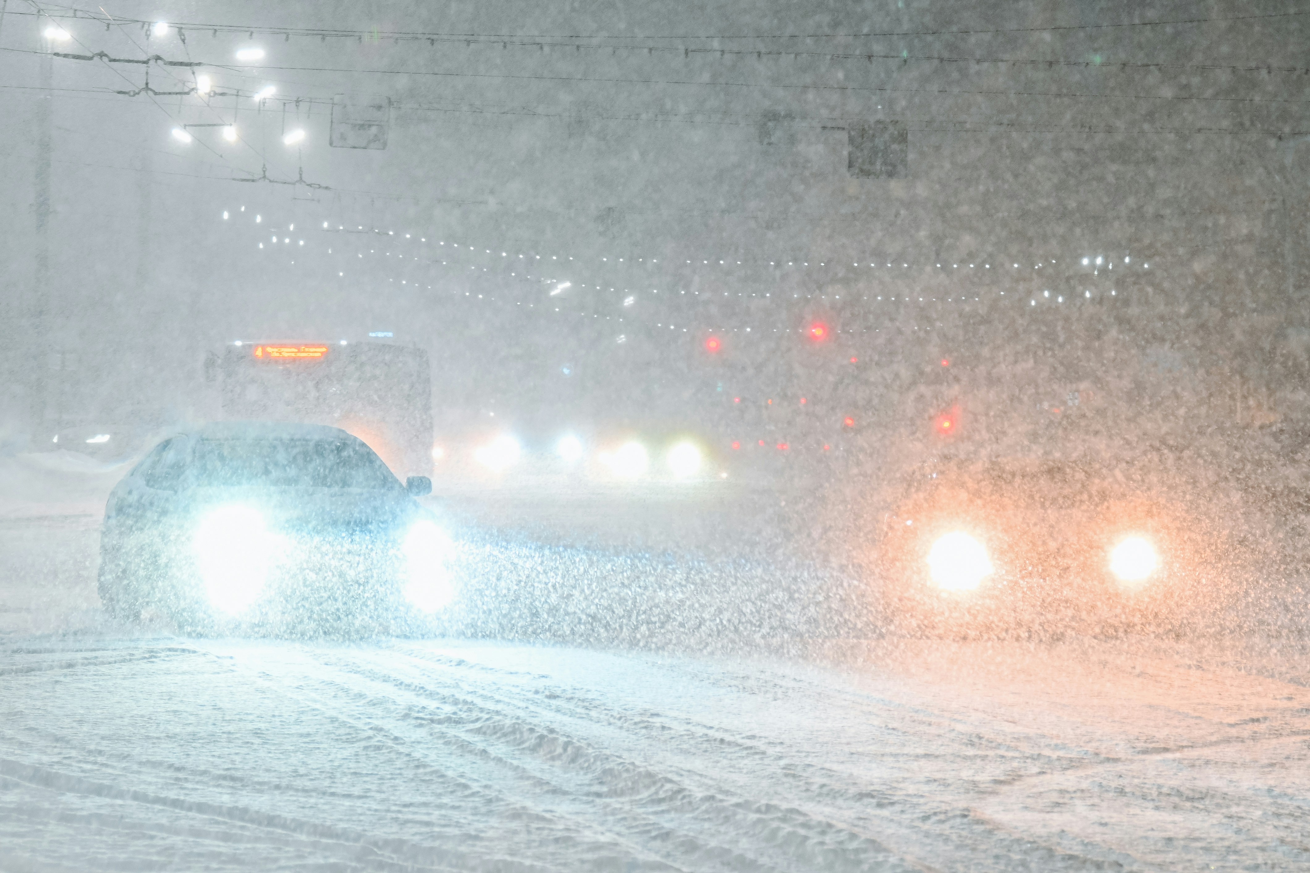 a car driving down a snow covered road