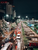 Night-time shot of a busy urban street with cars and bikes seamlessly integrated via smart technology.