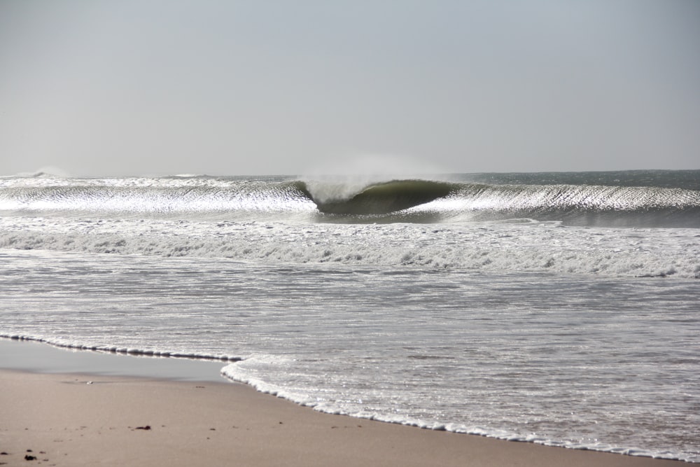 a large wave is coming in to the shore