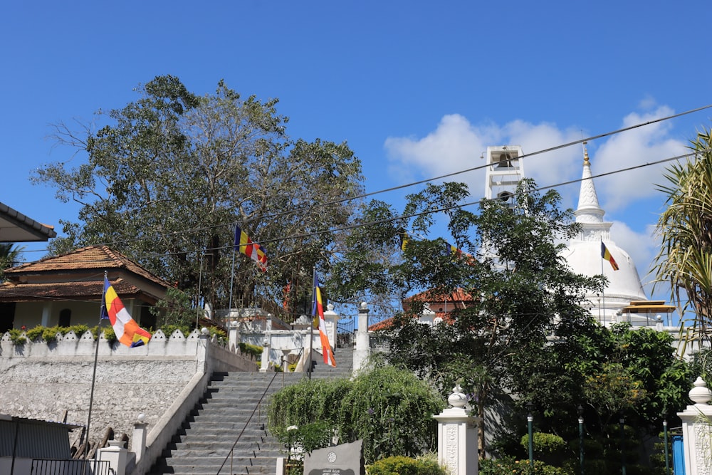 a white church with a steeple and flags on it