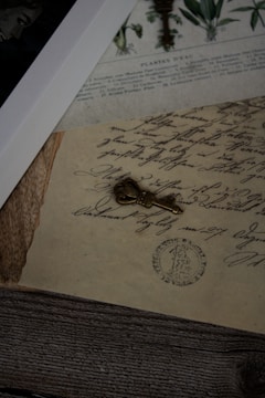 a key laying on top of a piece of paper