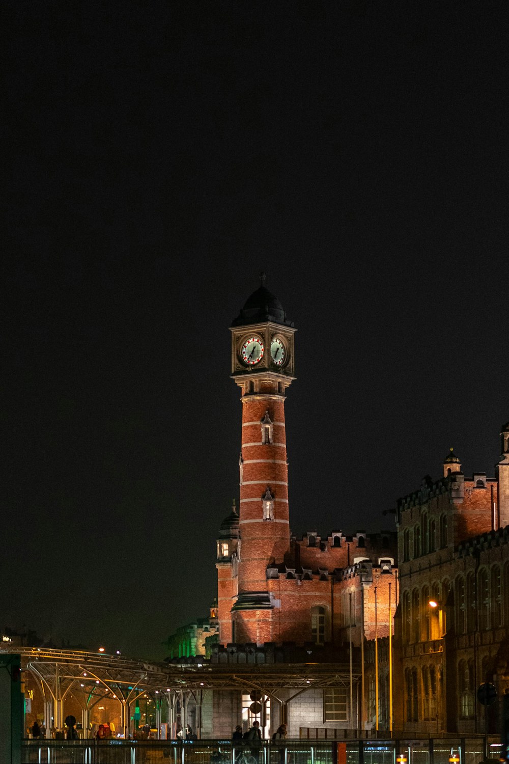 a tall clock tower towering over a city at night