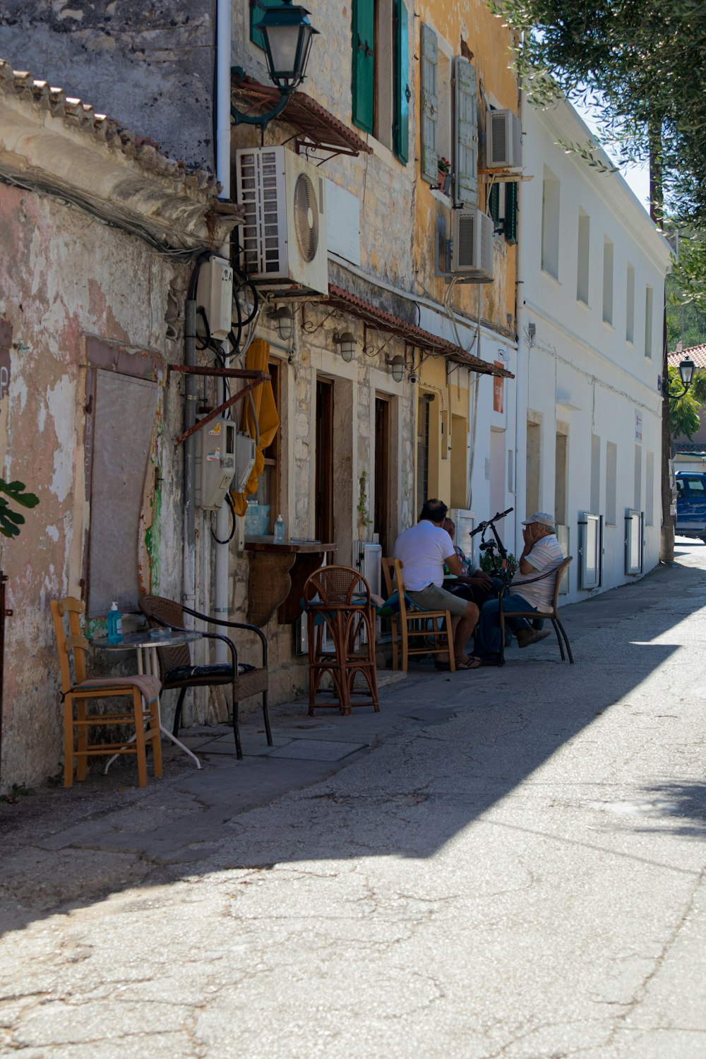 a group of people sitting at a table outside of a building