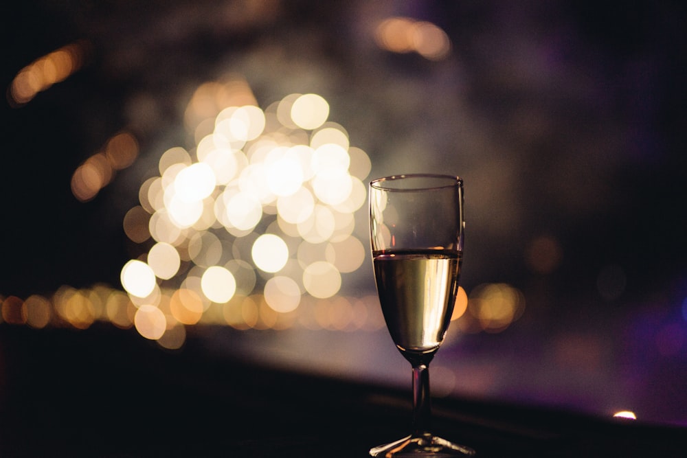 a glass of wine sitting on top of a table