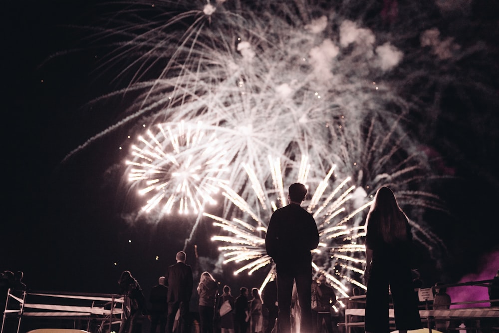 a group of people watching a fireworks display