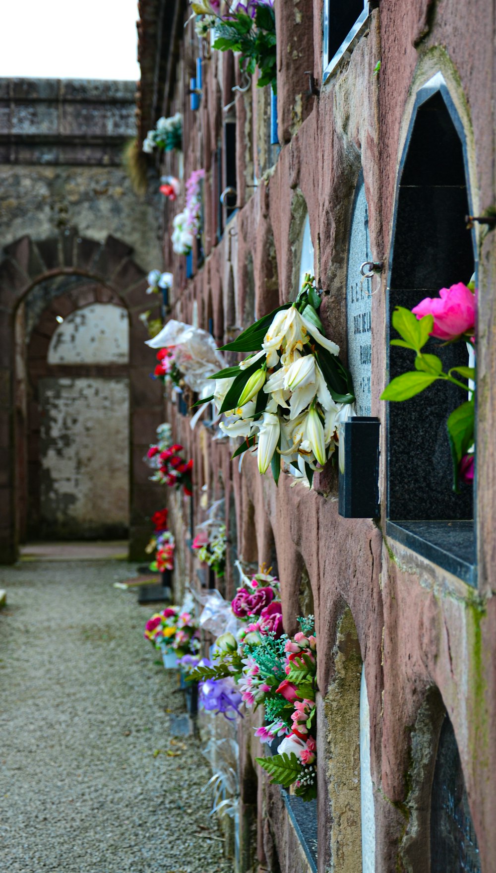 a brick wall with a bunch of flowers on it